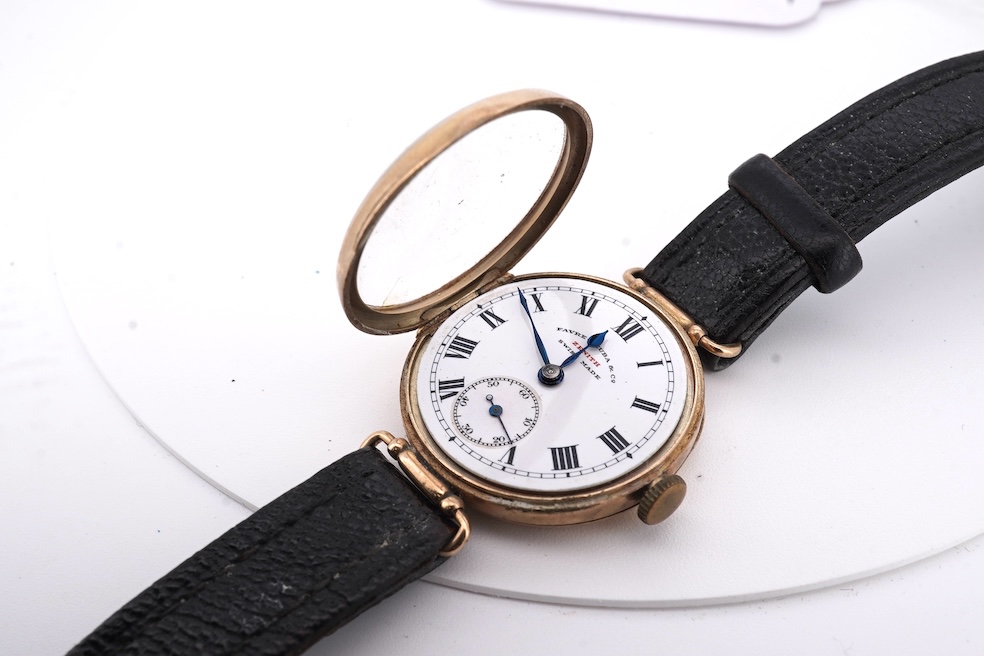 An early 20th century 9ct gold Zenith manual wind wrist watch, retailed by Favre Leuba, with Roman dial and subsidiary seconds, case diameter 28mm, on an associated leather strap. Condition - poor to fair